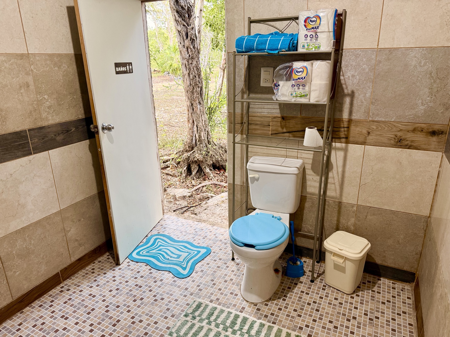 Private bathroom with toilet and sink for glamping guests.